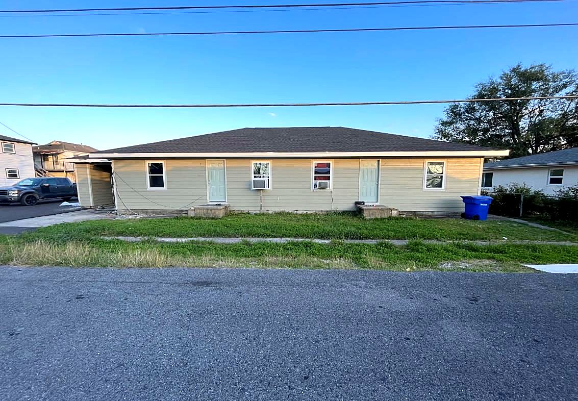 Same single-story units after renovation with new roof, siding, windows and doors