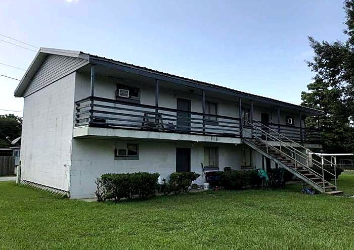 Two-story apartment complex with balconies before renovation